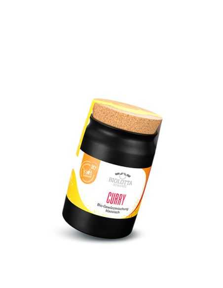 Schwarzes Keramiktöpfchen mit gelbem Etikett mit der Aufschrift „CURRY Bio-Gewürzmischung klassisch“ und Korkdeckel.