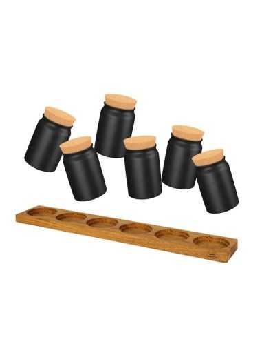 Sechs schwarze Keramiktöpfchen über einem länglichen Holzhalter mit sechs runden Vertiefungen.