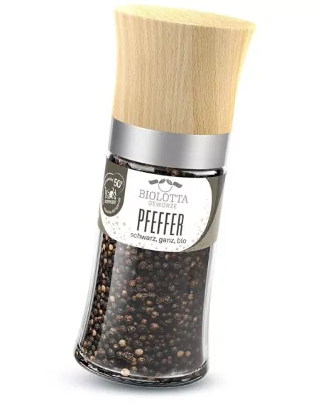 Gewürzmühle mit schwarzen Pfefferkörnern und grünem Etikett.