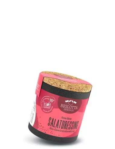 Bio-Pappdose mit pinkfarbenem Etikett mit der Aufschrift „SALATDRESSING“.