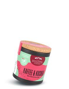 Schwarze Pappdose mit pink-grünem Etikett mit der Aufschrift Kaffe & Kuchen, Bio-Gewürzzucker