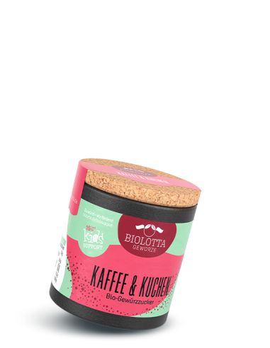 Schwarze Pappdose mit pink-grünem Etikett mit der Aufschrift Kaffe & Kuchen, Bio-Gewürzzucker