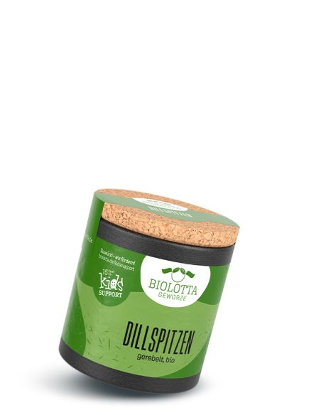 Grüne Pappdose mit schwarzem Boden, Korkdeckel und der Aufschrift „Dillspitzen, gerebelt, bio“ leicht schräg stehend.