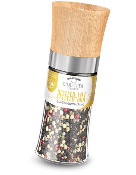 Transparente Gewürzmühle mit gelbem Etikett mit der Aufschrift „PFEFFER-MIX Bio-Gewürzmischung“ und Holzdeckel.