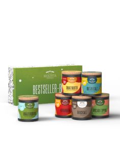 Grüne Geschenkbox mit der Aufschrift „Bestseller-Box“, davor sechs bunte Bio-Pappdosen mit verschiedenfarbigen Etiketten.
