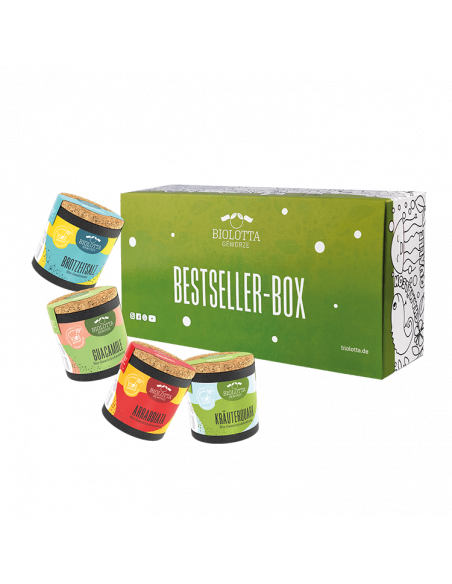 Vier bunte Bio-Pappdosen mit verschiedenfarbigen Etiketten und weißer Aufschrift, schräg angeordnet.