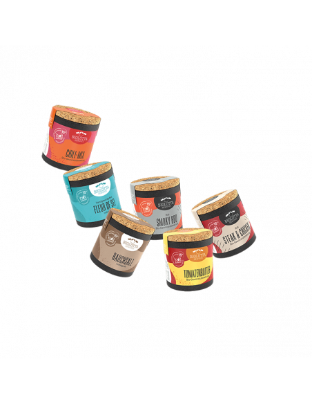 Sechs bunte Bio-Pappdosen mit verschiedenfarbigen Etiketten und weißer Aufschrift, schräg angeordnet.