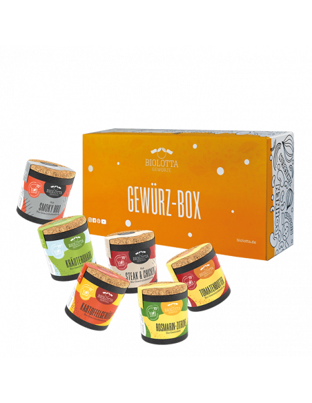 Sechs bunte Bio-Pappdosen vor einer orangefarbenen Geschenkbox mit der Aufschrift „Gewürz-Box“